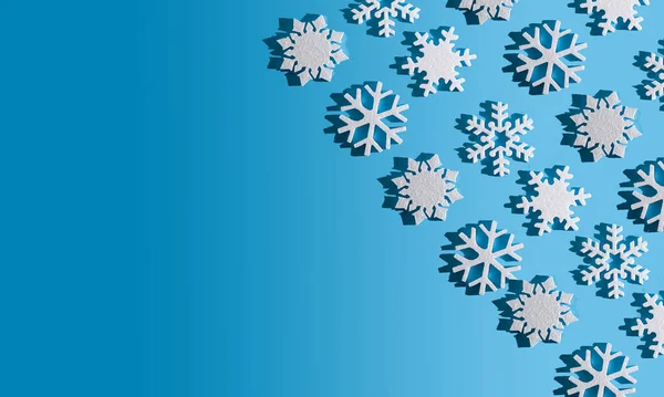 Christmas background. Snowflake pattern. White snowflakes on blue. Snow. Winter mood. Conceptual abstraction. Styrofoam snowflake. New Years pattern. Copy space. Texture.
