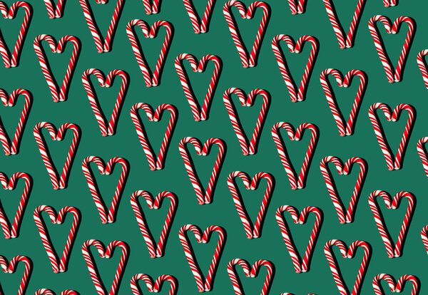 Паттерн красно-белых лебедей на зеленом фоне. Рождественская идея. Конфеты в форме сердца. Продукты питания.