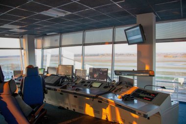 The workplace of the flight dispatcher in the airport. Flight control tower. Aviation background. Air Traffic Manager. Armchair and remote control with screen. Air Traffic Controller room.