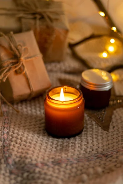 A set of different aroma candles in brown glass jars. Scented handmade candle. Soy candles are burning in a jar. Aromatherapy and relax in spa and home.