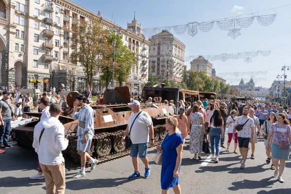 Exhibition of destroyed burnt Russian military equipment on Khreschatyk. Tank, armored personnel carrier and Ukrainian people on the street during the war with Russia. Ukraine, Kyiv - August 21, 2022.