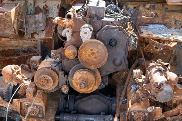 A fragment of a rusty burned-out car of Russia. Engine under the hood. APC Armored car salon. Exhibition of destroyed burnt Russian military equipment on Khreschatyk.