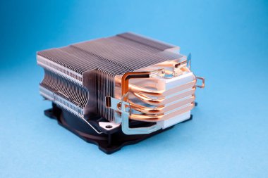 Computer heatsink cooler on blue background. Detail of a personal computer.