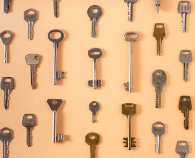 Key pattern. Background from different old keys. view from above. Door key in white and yellow metal.