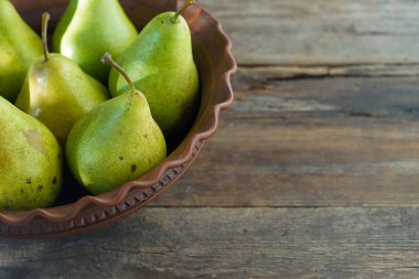 Ahşap arka planda armutlar. Meyve hasadı. Sonbahar hala hayattır. Armut çeşitliliği Bera Konferansı.