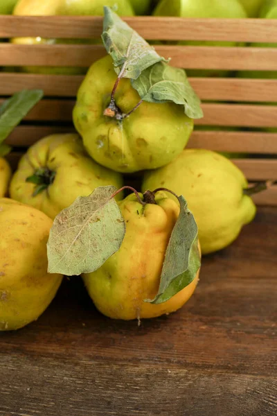 Quince fruit. Still life on a wooden background. Ripe quince fruits. Vitamin food.
