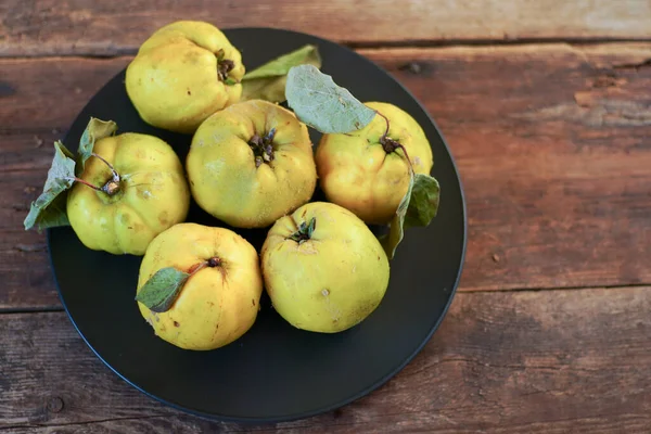 Quince fruit. Still life on a wooden background. Ripe quince fruits. Vitamin food.