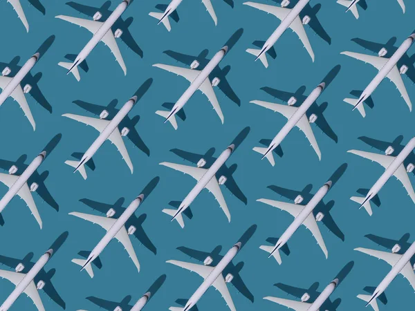 Airplane background. Flights, travel and aviation. Pattern of white planes on a blue background. The passenger plane is flying. Air transport concept.