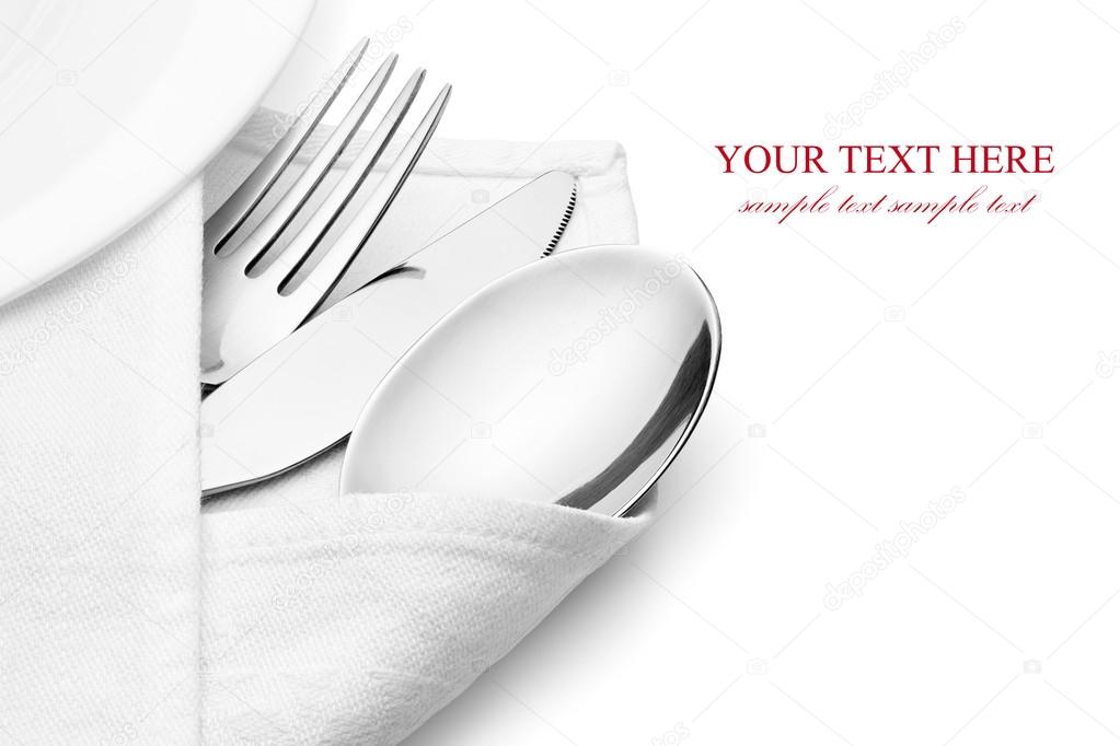 Knife, fork and spoon with linen serviette.