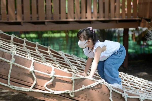 Cute Little Asian Girl Climbing Rope Net Playing Playground Little — Zdjęcie stockowe