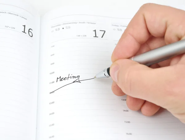 Hand with a pen and schedule — Stock Photo, Image