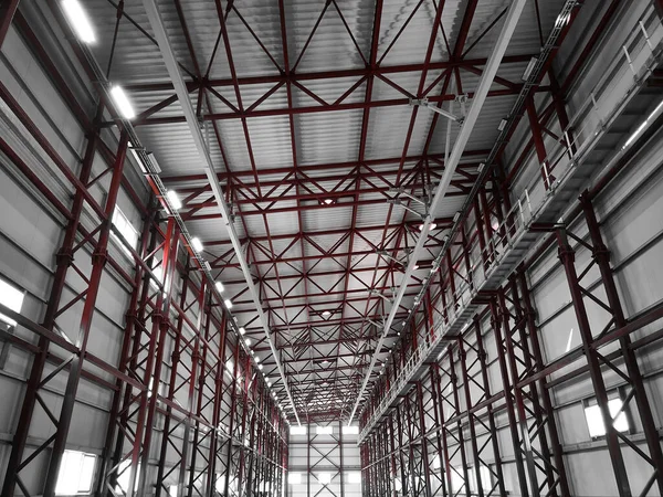 Truss ceiling and metal pillars and girders. Support constructions. Industrial building metal framework. Low angle view