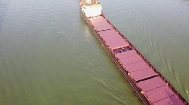 Aerial view of bulk carrier sailing down the river. River-to-sea cargo transportation