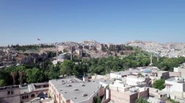 Aerial view of Sanliurfa Castle, rooftops, park around Balikligol and Mevlidi Halil Mosque. Historical and most visited part of Sanliurfa city, southeastern Anatolia, Turkey