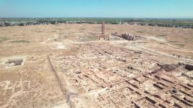Aerial view of archaeological excavation site of Harran University and waving Turkish flag on a flagpole. Ruins of the worlds oldest university. Harran, Sanliurfa province, Turkey