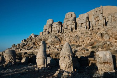 Heads of Apollo-Mithra-Helios-Hermes, Heracles-Artagnes-Ares and Persian Eagle statues. Statues on eastern terrace of Nemrut Mount, Adiyaman province, Turkey. UNESCO World Heritage Site