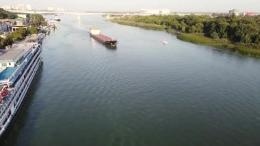 Aerial view of bulk carrier sailing down the river. River-to-sea cargo transportation