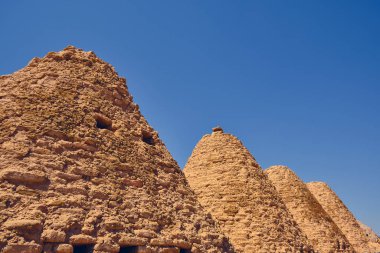 Traditional mud brick or adobe made beehive houses. Harran, major ancient city in Upper Mesopotamia, nowadays is a district in Sanliurfa province, Turkiye. Roofs of beehive houses opposite clear sky