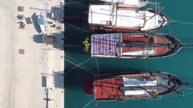 Top down aerial view of yachts moored to pier. Luxury boats parked in marina