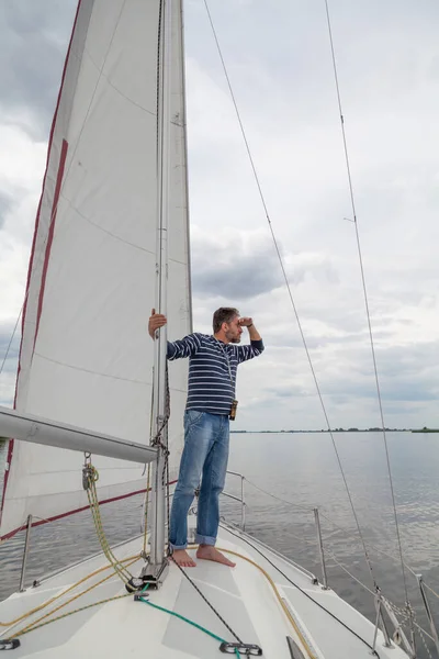 Captain Holds Mast Man Striped Sweater Jeans Sits Nose Sailing — Stock Photo, Image