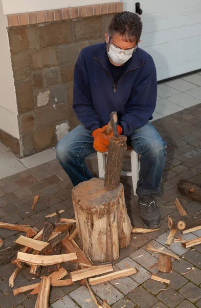 Man Sits Front Tree Stump Chops Wood Wears Goggles White — стоковое фото