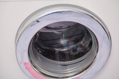 Round glass door of modern washing machine close u