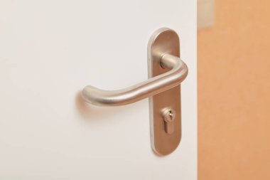 Modern design metal handle on an interior doo