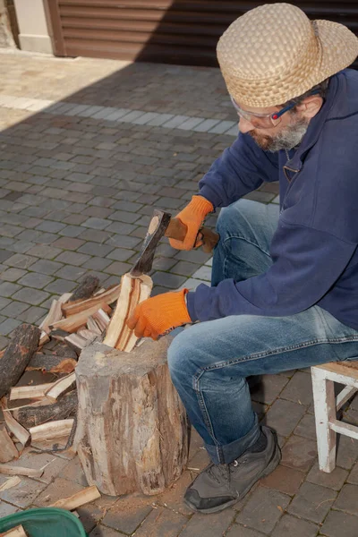 Man Beard Sits Front Tree Stump Chops Wood Wearing Safety — Stock Photo, Image