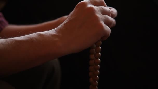 Man Sorting Two Hands Wooden Rosary Black Background Close Dim — Stock Video