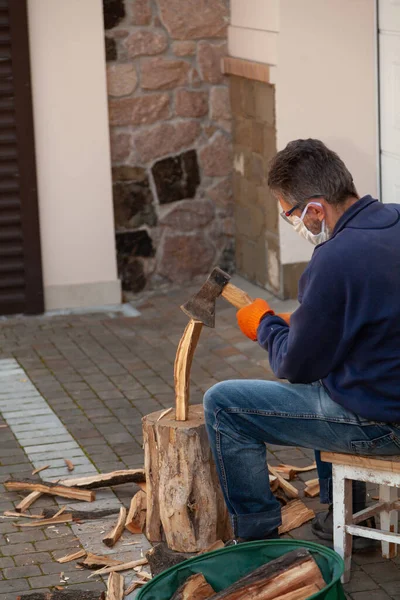 Man Sits Front Tree Stump Chops Wood Wears Goggles White — стоковое фото