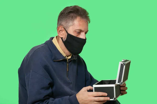 Secret Mission Man Black Protective Mask Opens Case Isolated Green — Stockfoto