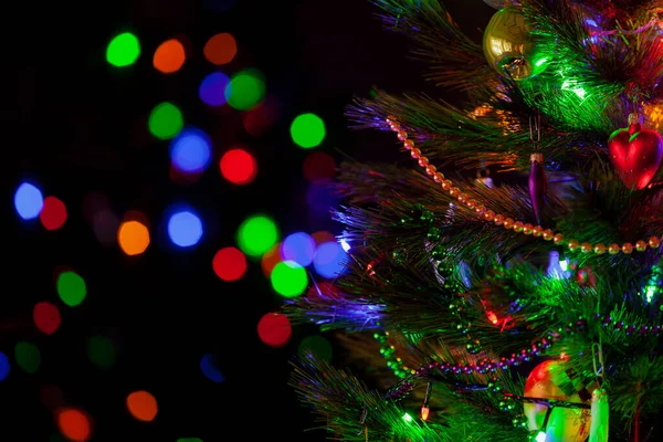Green Christmas Tree Festively Decorated Toys Luminous Garlands Stands Dark — Zdjęcie stockowe