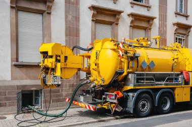 Sewerage truck on street working clipart