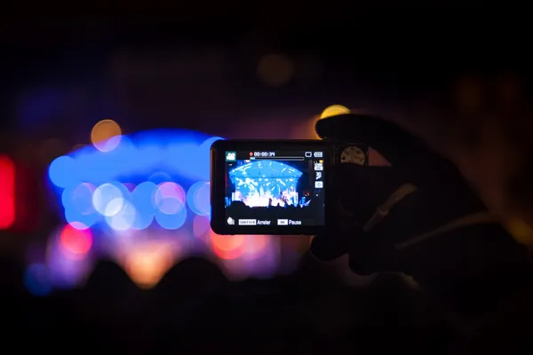 Taking video with smartphone during a public concert — Stock Photo, Image