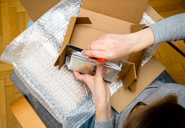 View from above of woman hand unboxing unpacking Western Digital HDD hard disk drive in plastic bubble wrap protection packaging — Stock Photo, Image