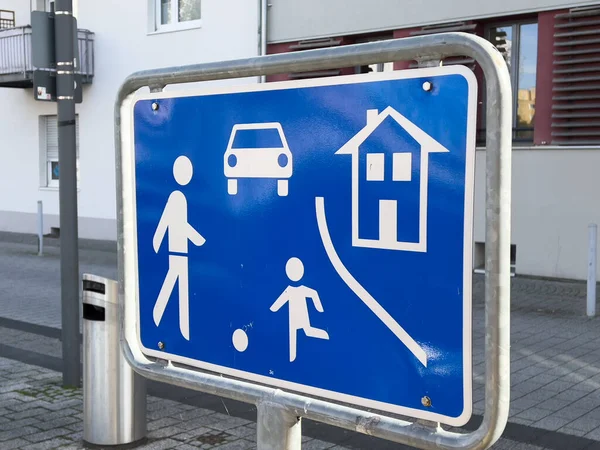 German street with blue sign warning for driver entering pedestrian area — Stock Photo, Image