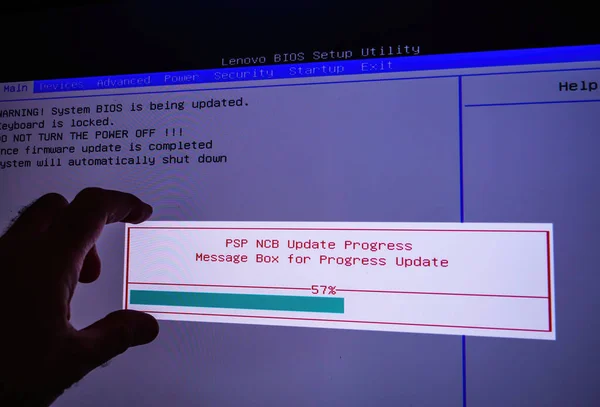 POV male hand on the touchscreen display during bios update of Lenovo computer workstation — стоковое фото