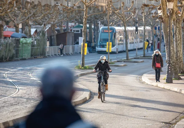 Woman on bike pedestrians with respiratory masks — Stock Photo, Image