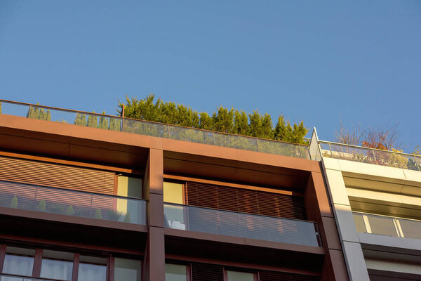 Low angle view of modern apartment building with clear blue sky in the background