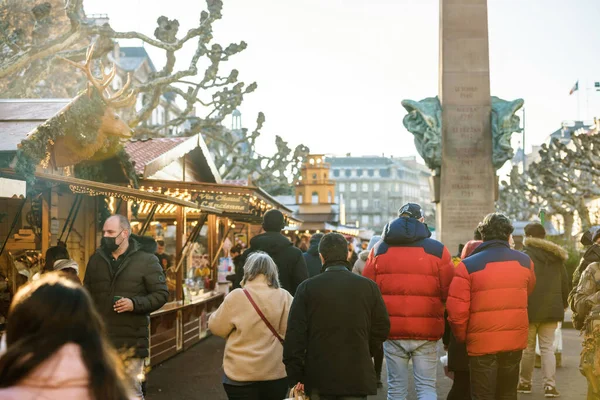 Menigte dragen ademhalingsbescherming maskers tijdens de kerstmarkt in Place Broglie als gevolg van COVID-19 — Stockfoto