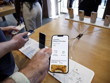 Male hand holding new silver iPhone 13 Pro Max smartphone model