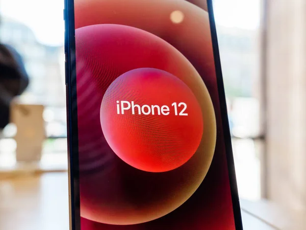 Hero object of the new red iPhone 12 on display during launch da — Photo