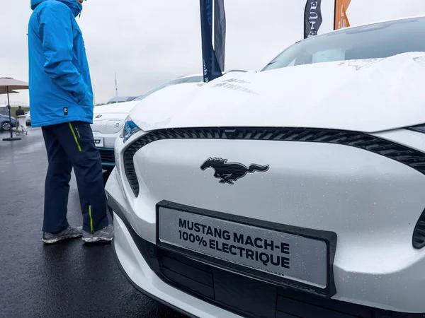 Customer looking before buying at the outdoor parked new Mustang Mach-E car electric EV car — Stock Fotó