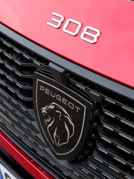 New redesigned modern Peugeot Logotype on the red 308 electric car — 스톡 사진