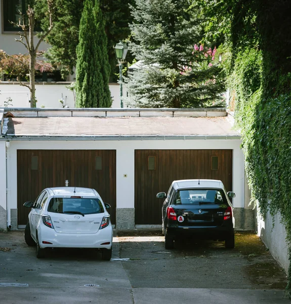 Aerial view of two cars parked in front of two garages - Toyota yaris and Skoda Fabia — Photo