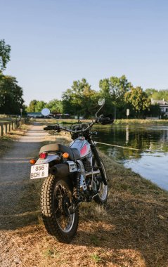 Rear view of beautiful luxury Yamaha motorcycle parked near the river