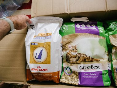 cardboard with multiple cat pet food - Royal Canin and Cats Best litter inside