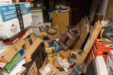Garage mess with multiple cardboard packages after unboxing thousands of items from amazon