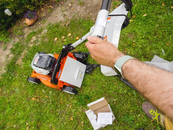 POV male handle on the steering of Stihl new lawn mower adter unboxing — Stockfoto