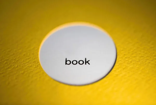 Book brochure text on the white circle with yellow cover — стоковое фото